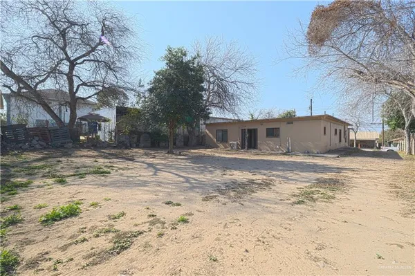 a front view of a house with a yard covered with snow