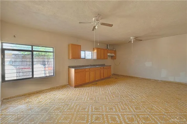 a view of a kitchen with a sink and a window