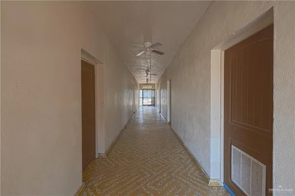 a view of a hallway with windows