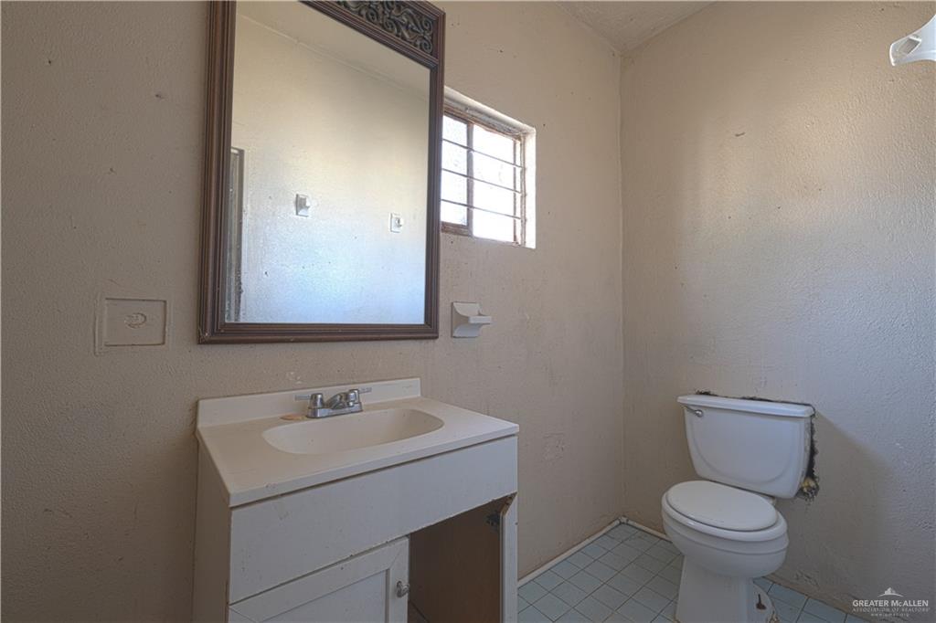 1106 Estrella Street Roma, TX 78584 - Photo 6 of 13 a bathroom with a toilet sink and mirror