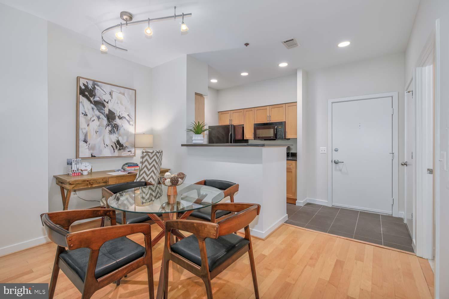 3883 Connecticut Avenue Northwest, Unit T3 Washington, DC 20008 - Photo 13 of 25 a dining room with furniture and a wooden floor