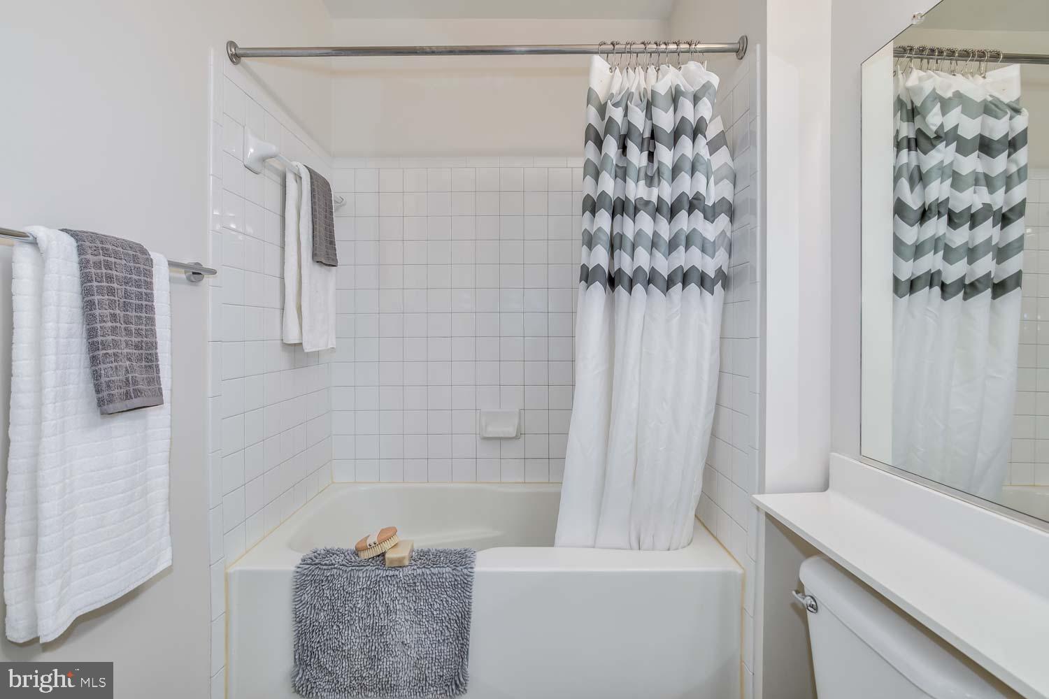 3883 Connecticut Avenue Northwest, Unit T3 Washington, DC 20008 - Photo 19 of 25 a bathroom with a shower curtain and a sink