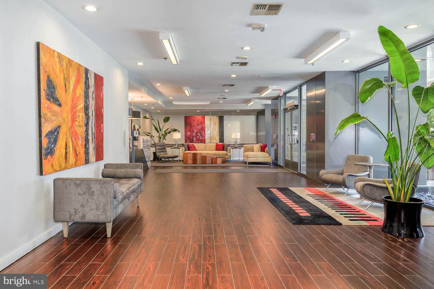 3883 Connecticut Avenue Northwest, Unit T3 Washington, DC 20008 - Photo 2 of 25 a living room with furniture and a wooden floor