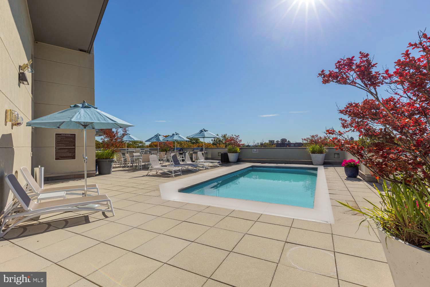 3883 Connecticut Avenue Northwest, Unit T3 Washington, DC 20008 - Photo 21 of 25 a white house with a yard and seating space