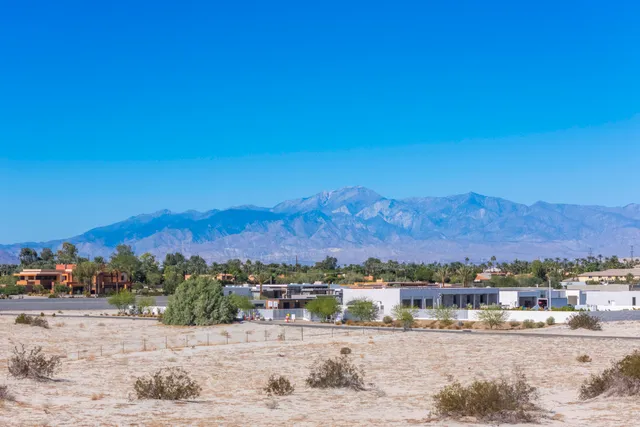a view of a town with mountains in the background