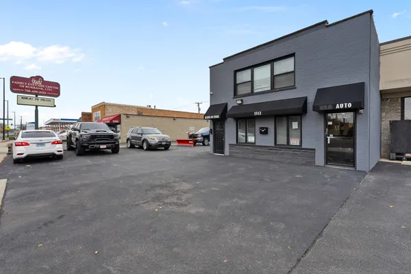 a front view of a building with parking space