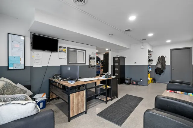 a workspace with furniture and a flat screen tv