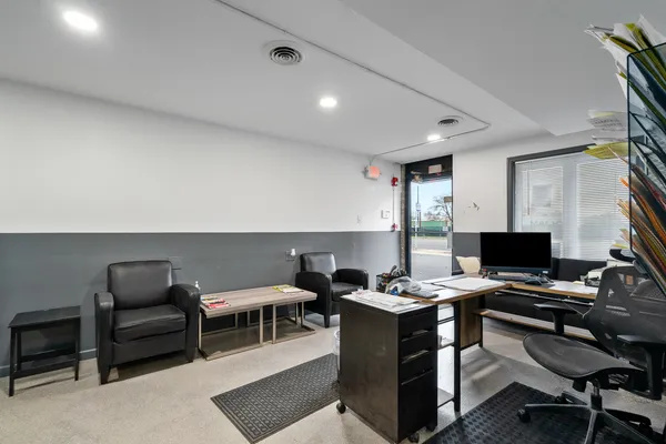 a workspace with furniture and a ceiling fan