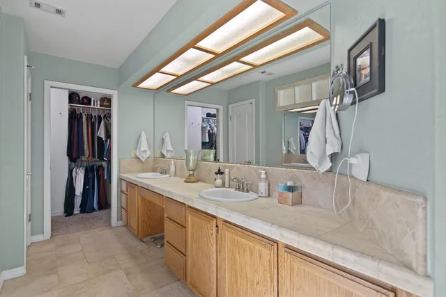 a bathroom with a double vanity sink and a mirror