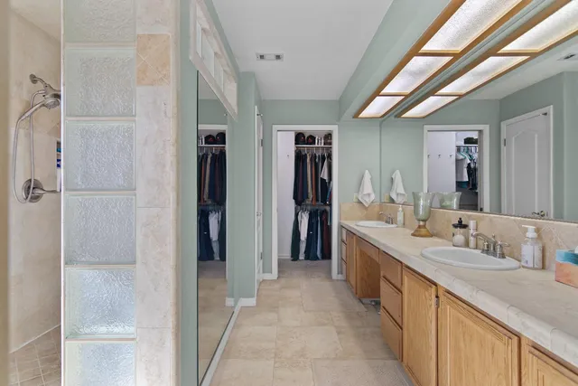 a bathroom with a double vanity sink and a mirror