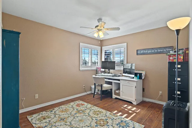a view of a workspace with furniture and a window