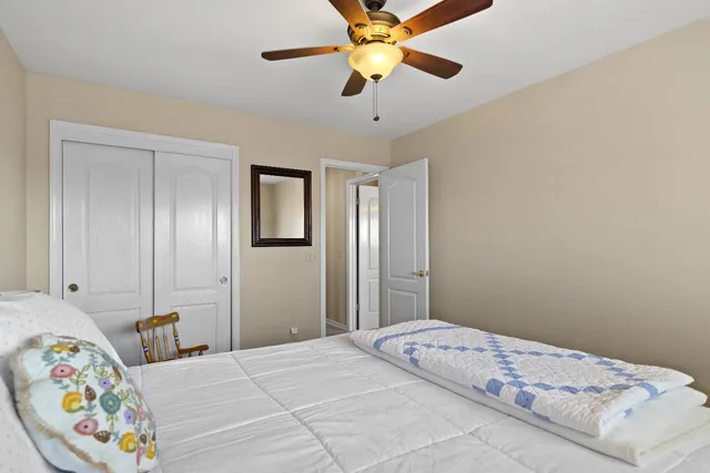 a bedroom with a bed and a chandelier