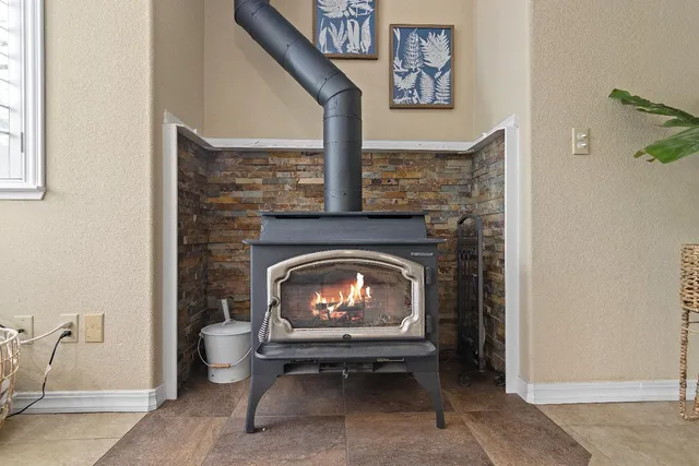 a living room with a fireplace and a rug