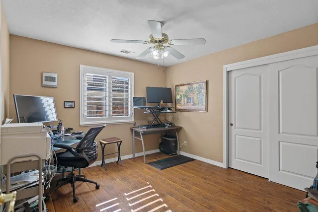 a view of a workspace with furniture and a window