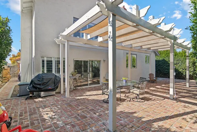 a view of a chair and tables in the patio