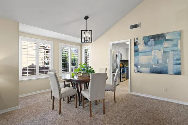 a view of a dining room with furniture window and outside view