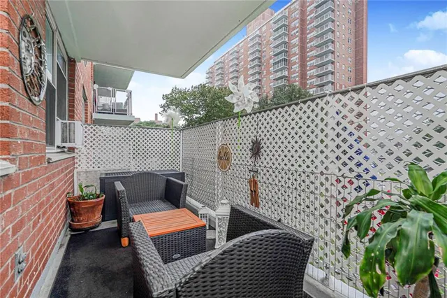 a view of a brick wall with seating space