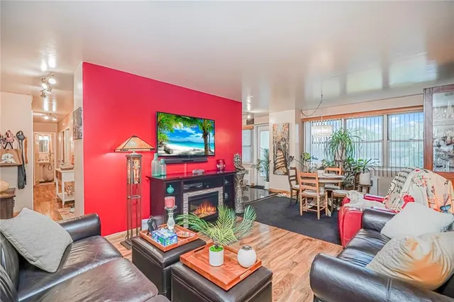 a living room with furniture a large window and a fireplace
