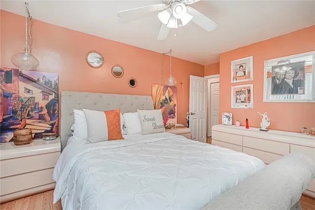 a bedroom with a large bed and a chandelier