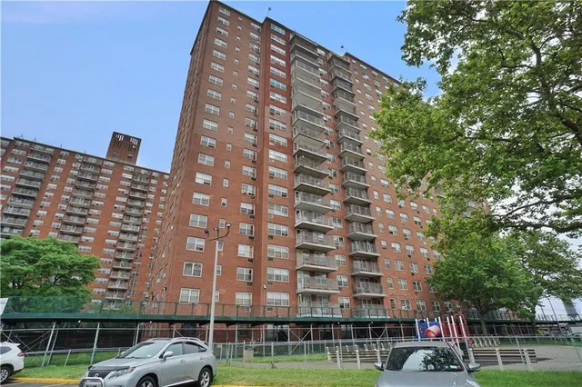 a view of a tall building with a yard