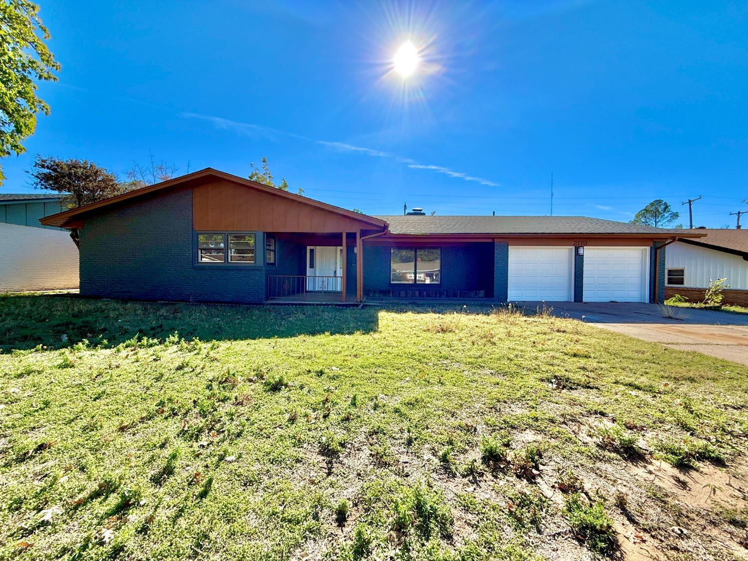 2119 67th Street Lubbock, TX 79412 - Photo 1 of 42 a front view of a house with a yard
