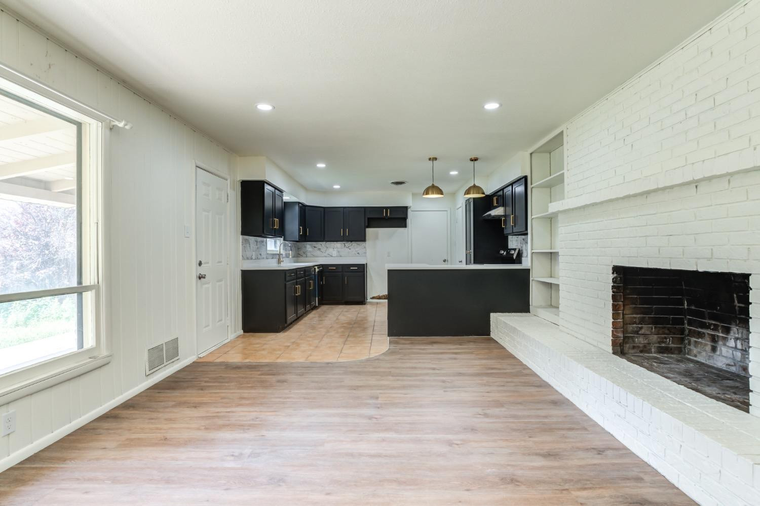 2119 67th Street Lubbock, TX 79412 - Photo 13 of 42 a large kitchen with a stove top oven and kitchen view