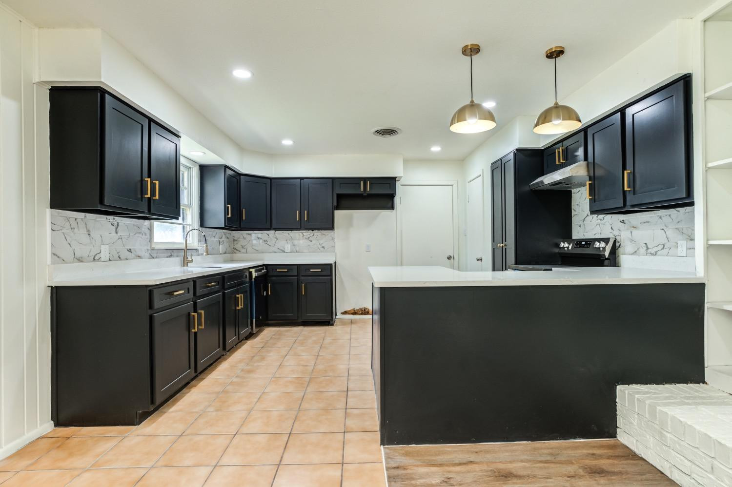 2119 67th Street Lubbock, TX 79412 - Photo 19 of 42 a kitchen with a sink stainless steel appliances and cabinets