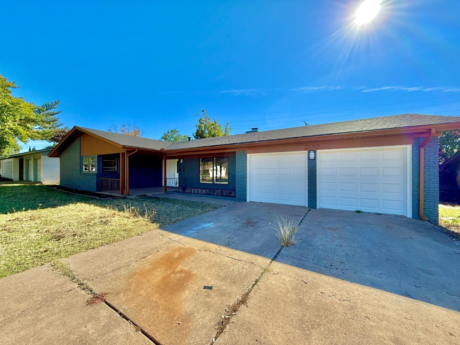 2119 67th Street Lubbock, TX 79412 - Photo 2 of 42 a view of a house with a backyard and a garage