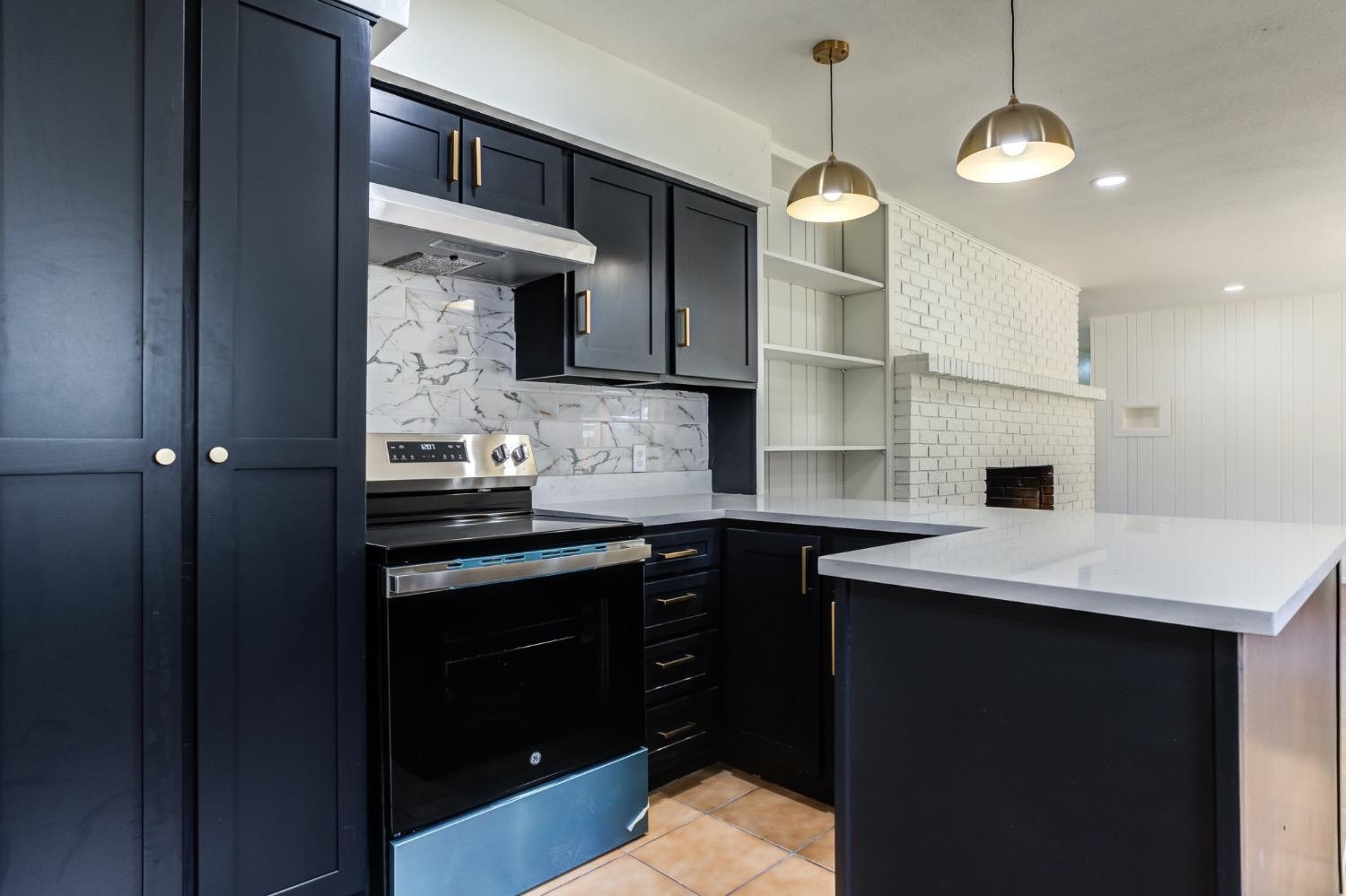 2119 67th Street Lubbock, TX 79412 - Photo 21 of 42 a kitchen with a sink and a stove top oven