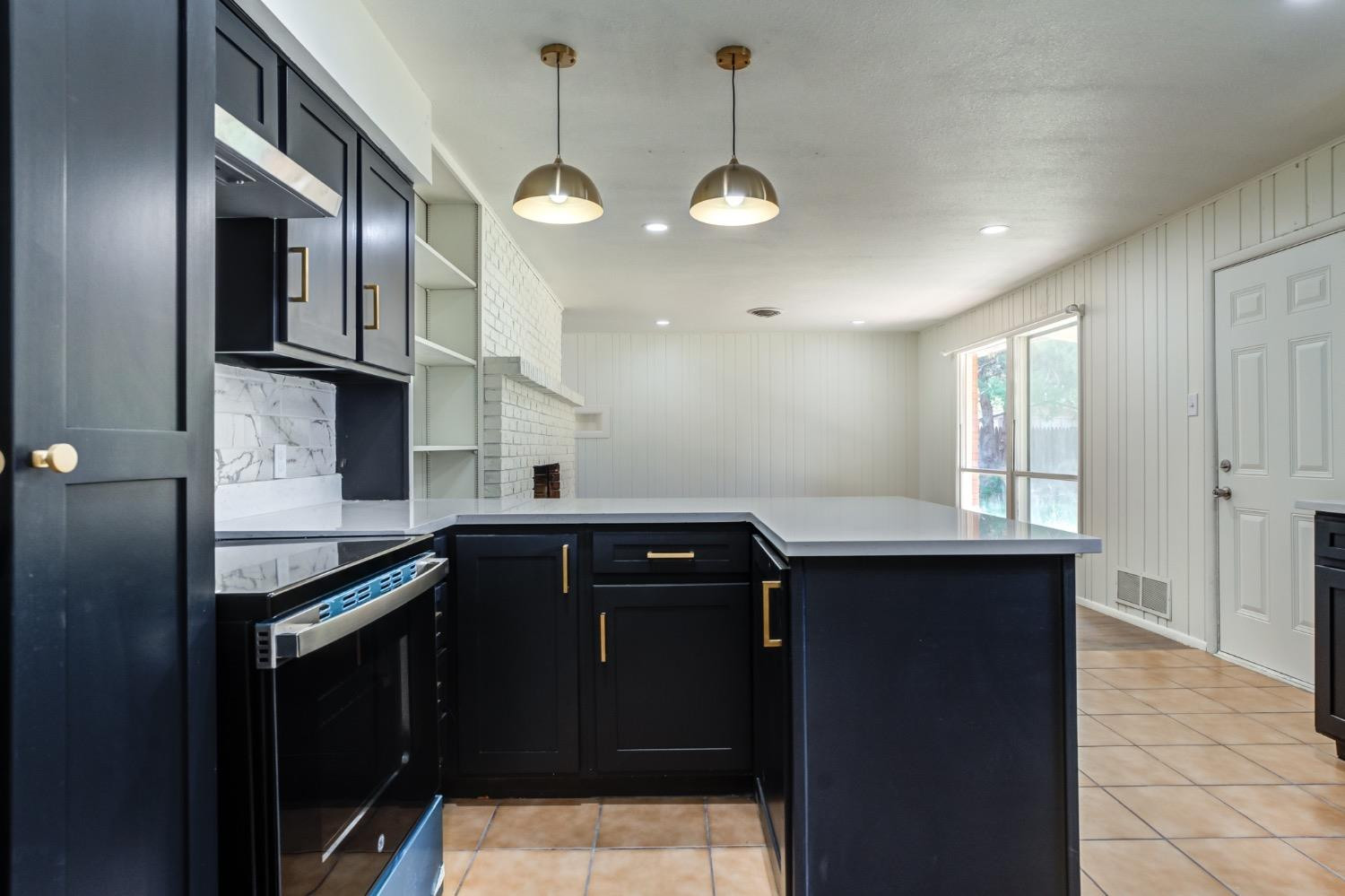 2119 67th Street Lubbock, TX 79412 - Photo 22 of 42 a kitchen with stainless steel appliances granite countertop a sink a stove and refrigerator