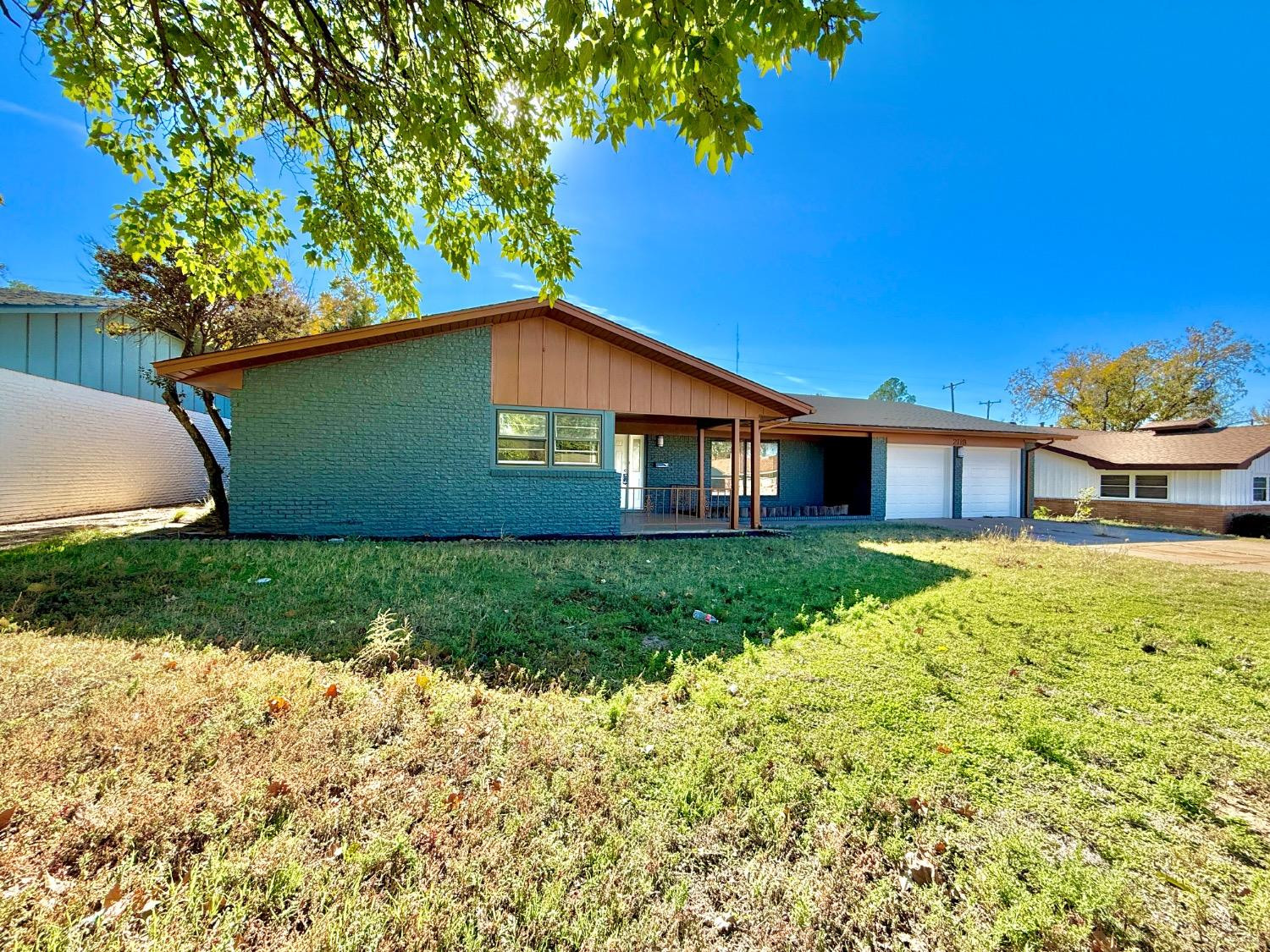 2119 67th Street Lubbock, TX 79412 - Photo 3 of 42 a front view of a house with a yard