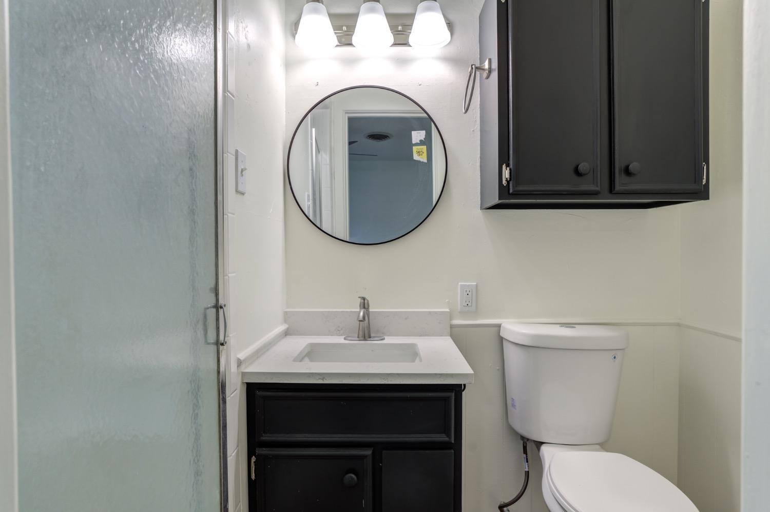 2119 67th Street Lubbock, TX 79412 - Photo 34 of 42 a bathroom with a toilet and a sink