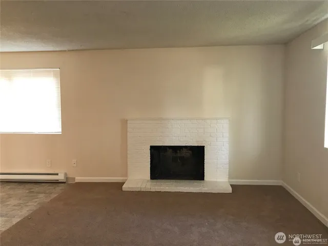 a view of empty room with a fireplace