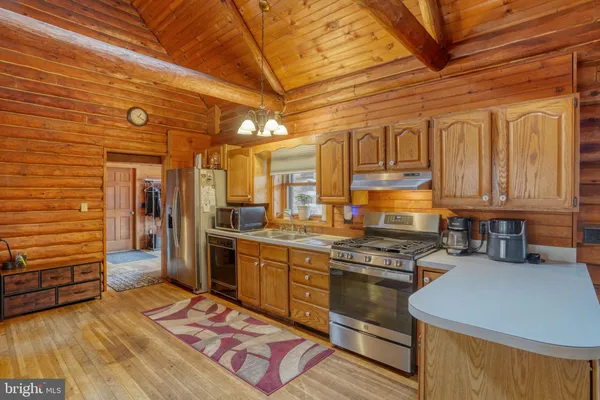 a kitchen with a stove a sink and a microwave