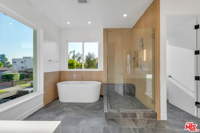 a bathroom with a tub and a shower
