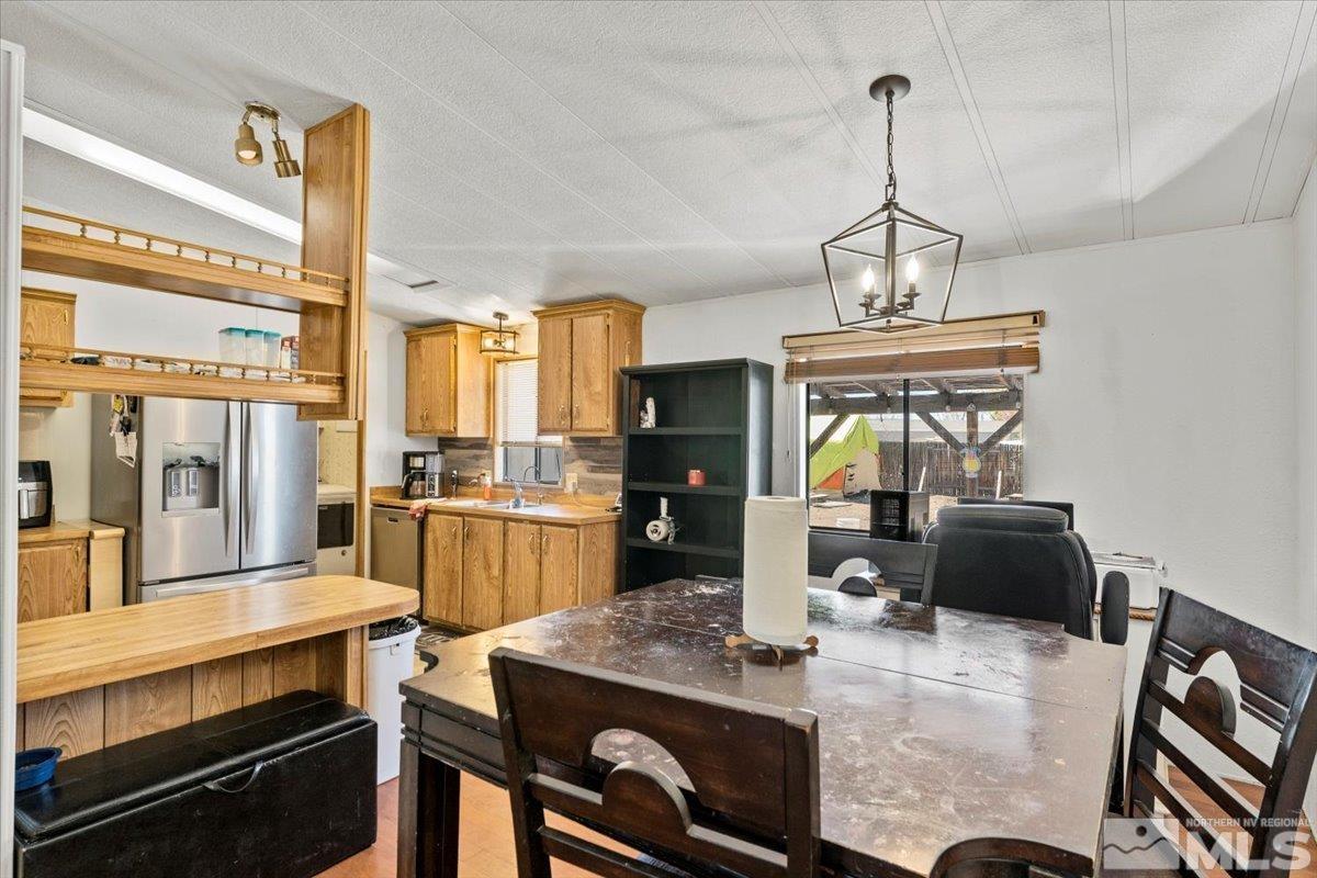 3867 Puffin Street Reno, NV 89508 - Photo 11 of 29 a kitchen with a stove and a chandelier