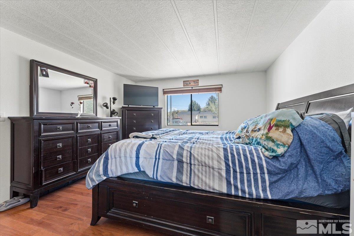 3867 Puffin Street Reno, NV 89508 - Photo 18 of 29 a bedroom with a bed and a dresser