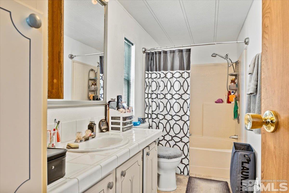 3867 Puffin Street Reno, NV 89508 - Photo 20 of 29 a bathroom with a sink toilet and shower
