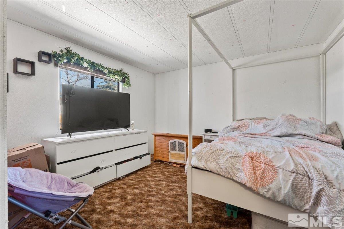 3867 Puffin Street Reno, NV 89508 - Photo 21 of 29 a bedroom with a bed and flat screen tv