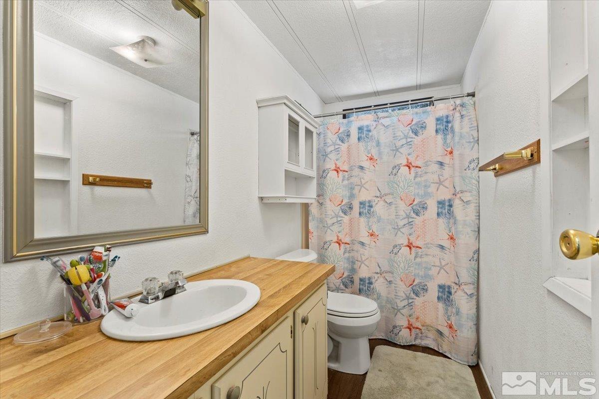 3867 Puffin Street Reno, NV 89508 - Photo 23 of 29 a bathroom with a sink toilet and shower