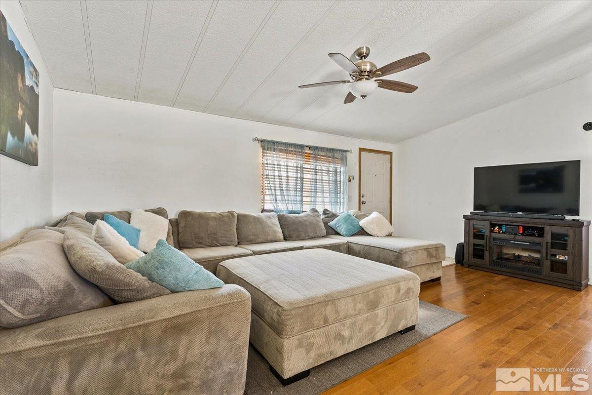 3867 Puffin Street Reno, NV 89508 - Photo 9 of 29 a living room with furniture and a flat screen tv