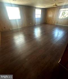21628 Great Mills Road, Unit A2 Lexington Park, MD 20653 - Photo 3 of 11 an empty room with wooden floor and windows
