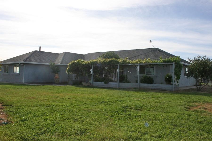 21215 Gyle Road Corning, CA 96021 - Photo 57 of 75 a front view of a house with a yard and garage