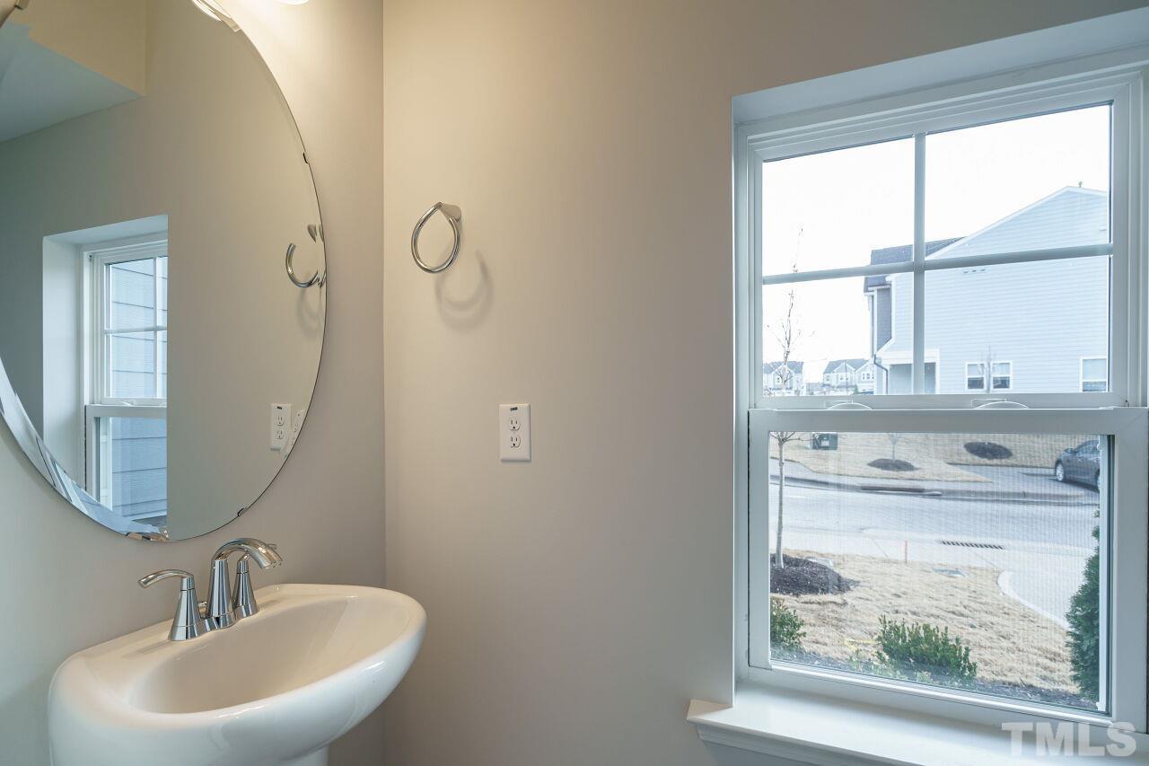 3113 Dunnock Drive, Unit 3 Durham, NC 27713 - Photo 15 of 30 a bathroom with a sink a mirror and a window