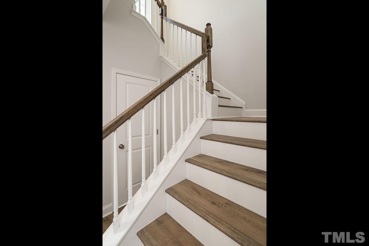 3113 Dunnock Drive, Unit 3 Durham, NC 27713 - Photo 16 of 30 a view of staircase with wooden floor and white walls