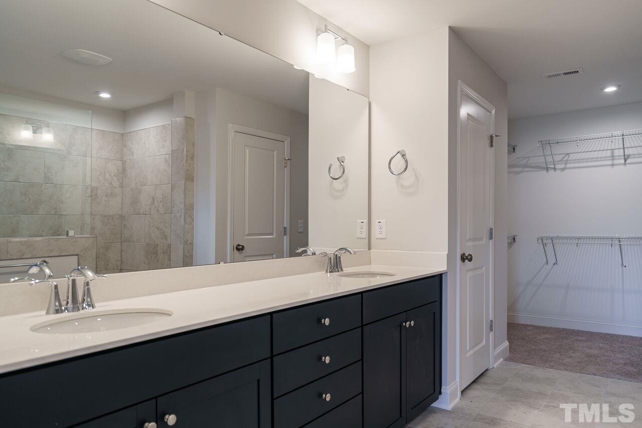 3113 Dunnock Drive, Unit 3 Durham, NC 27713 - Photo 22 of 30 a bathroom with double vanity sinks and a mirror