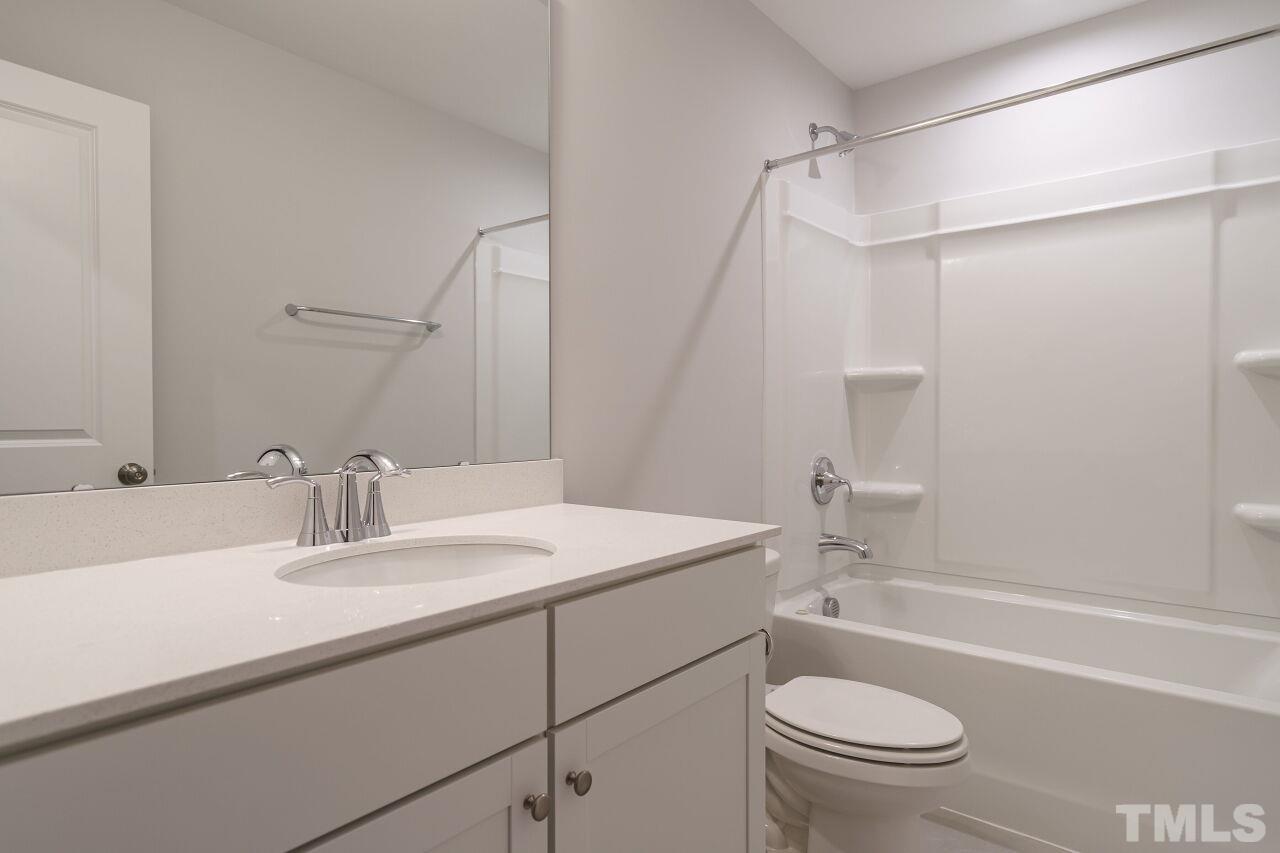 3113 Dunnock Drive, Unit 3 Durham, NC 27713 - Photo 27 of 30 a bathroom with a sink a toilet and shower