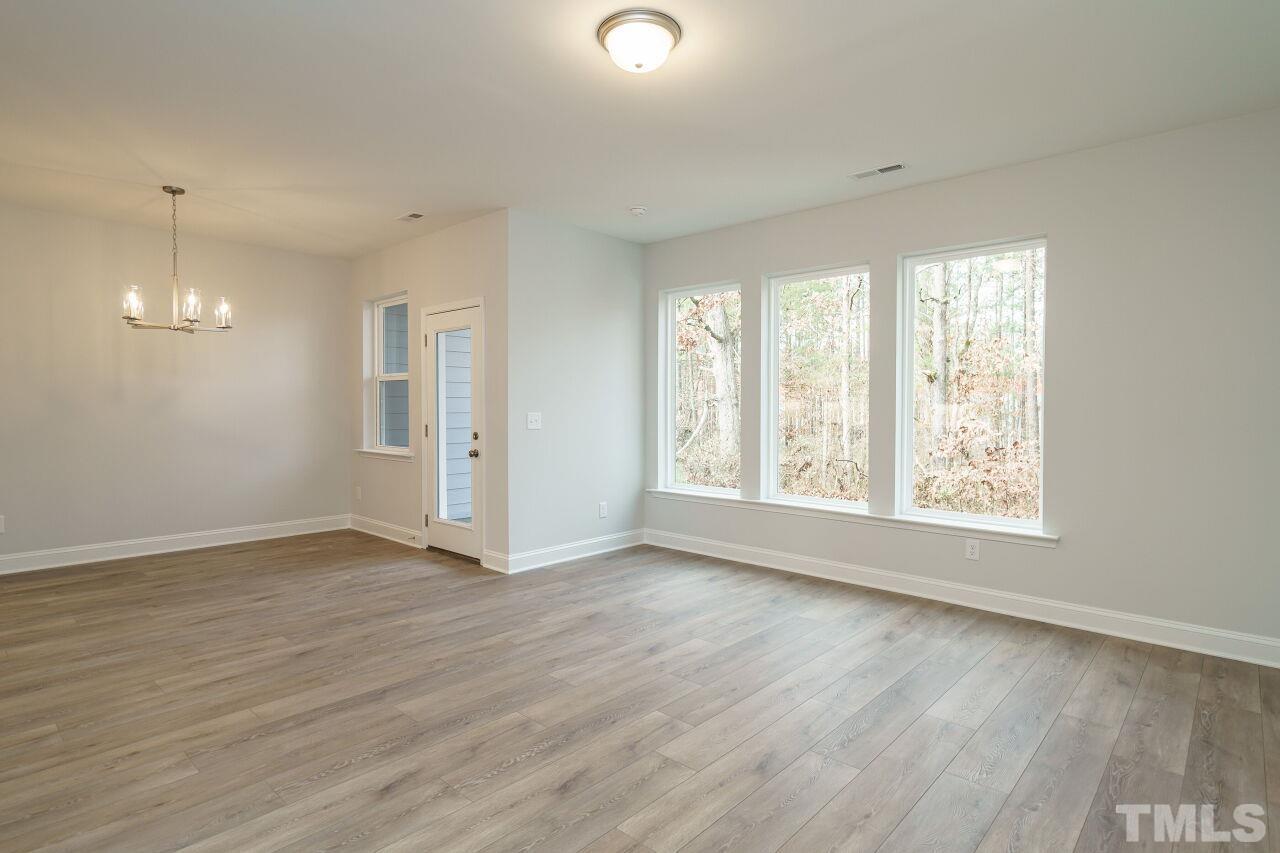 3113 Dunnock Drive, Unit 3 Durham, NC 27713 - Photo 6 of 30 an empty room with wooden floor and windows