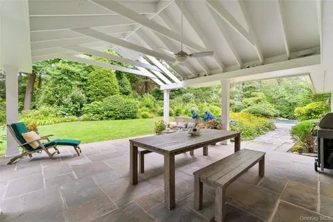 a view of a patio with a table chairs and a backyard