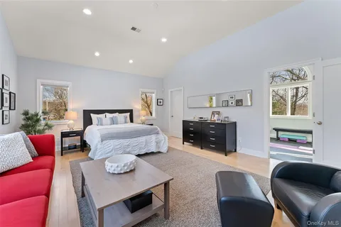 a bedroom with furniture and a flat screen tv